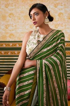 Green pre-draped saree featuring ambrosia striped print in brocade silk. Paired with a halter neck embellished blouse showcasing fleur print., Fit: Relaxed Draped Saree, Embellishment Details, Drape Saree, Embellished Blouse, Green Saree, Green Blouse, Printed Sarees, Striped Blouse, Sarees Online