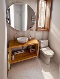 a bathroom with a sink, mirror and toilet