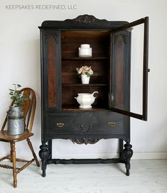 an old fashioned china cabinet with flowers in it