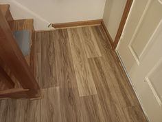 a bathroom with wood flooring and white walls