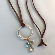 New Handcrafted Necklace Adjustable Approx To 30” Hammered Silver Circle Pendant Natural Gemstone Prasiolite Teardrop Pale Green Tone, Blue Aquamarine Briolette, Clear Faceted Quartz Pear Shape Wrapped In Gold Plated Metal Brown Color Sueded Strand Of Deerskin Leather Cord Handcrafted In California Bundle Up And Save Even More 10% Please Review My Other Handcrafted Unique Jewelry On Sale Fast Shipping Everyday Silver Leather Necklace, Silver Leather Dangle Jewelry, St Christopher Necklace, Leather Cord Necklace, Green Tone, Braided Necklace, Vintage Beads Necklace, Leather Corded Necklace, Layered Necklace Set