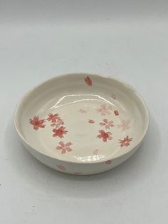 a white bowl with pink flowers on it