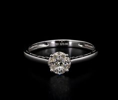 a diamond ring on a black background