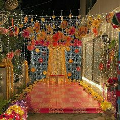 an outdoor stage decorated with flowers and garlands for a wedding or special event in the evening