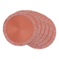 set of four round woven placemats in coral pink