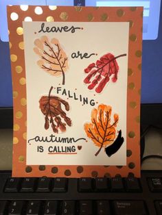 a handprinted card with autumn leaves and saying leaves are falling, autumn is calling