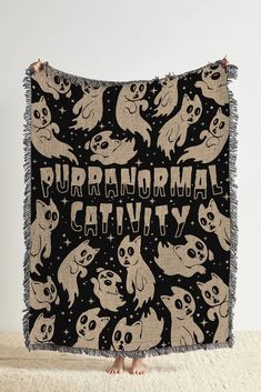 a black and white blanket with cats on it that says purranonal catty