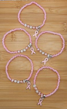 Breast cancer charm "Brave" stretchy bead bracelet in pink.  Made with glass beads and all bracelets are 7 1/4 inches long.   Created by Kelly in the USA! Please do not over stretch, may result in breakage.  Never leave small children unattended with items containing small pieces, potential choking hazard.  Beads may change colors overtime if worn in water or while applying product to the skin such as lotions. Check out my Etsy store for bracelets and more Kellyanndesigsgifts.etsy.com Pink Out Bracelets, Pink Out Ideas, Bead Friendship Bracelet, Stretchy Beaded Bracelet, Bracelet Inspo, Bracelets Ideas, Pink Day, Pink Out