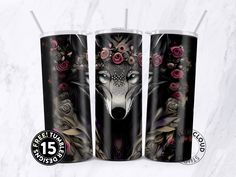 three black tumblers with pink roses and a wolf's head on them, sitting next to each other