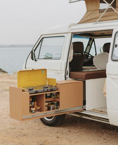 an open white van with its doors open and the back door opened to show it's contents