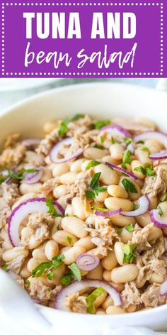 tuna and bean salad in a white bowl with red onions, cilantro and parsley