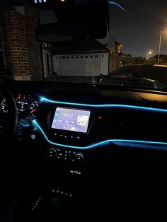 the interior of a car is lit up with blue leds and steering wheel controls