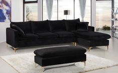 a black couch and ottoman in a living room