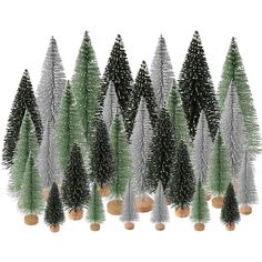 christmas trees are lined up in rows on wooden bases with white and green tinsels