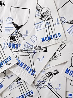 many pieces of white paper with blue ink drawings on them and the words mooku