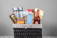 a basket filled with coffee, snacks and condiments on top of a table