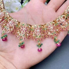 Featuring a beautifully carved necklace set in 22ct gold embellished with rubies emeralds and pearls. The necklace weighs 42.85 GMs including 4.92 GMs of hanging ruby emerald beads The earrings weigh 8.80 GMs including 0.72 GMs of hanging ruby emerald beads Price Breakup Summary Component Rupees % of Total 22k Gold 229,747 78.3% Stones & Beads 13,891 4.7% Making Charges 41,355 14.1% Taxes (GST) 8,550 3.0% Total 293,542 100.0% View Detailed Price Breakup Watch Video Here Festive 22k Yellow Gold Emerald Necklace, 22k Gold Green Necklace With Intricate Design, Green 22k Gold Necklace With Intricate Design, Festive 22k Gold Jeweled Necklaces, Festive Jeweled 22k Gold Necklaces, Festive Jeweled Yellow Gold Necklaces, Festive Yellow Gold Jeweled Necklaces, Festive Jeweled Yellow Gold Necklace, Festive Yellow Gold Emerald Necklace For Celebration