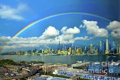 a rainbow in the sky over a city