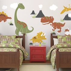 two beds in a room with dinosaur wall decals