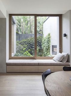 a dining room with a window seat and table