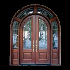 an arched wooden door with glass panels and sidelights on the top part of it