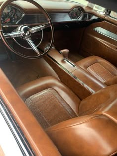 the interior of an old car with brown leather