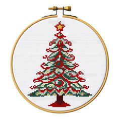 a cross stitch christmas tree in a hoop