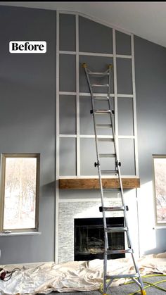 a ladder is in the middle of a room with gray walls and white paint on it