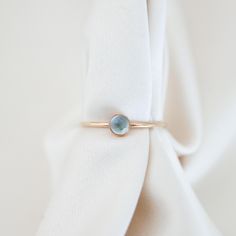 Everyone's favorite, aquamarine, shines in this ring. Its pale blue looks incredible in both silver and gold Details Band is 1 mm thick, stone is 4mm Gold fill or sterling silver Whole + Half sizes: US 3-14 (message us for smaller or larger sizes) See this page for ring sizing + conversions PS, check out our BFF, Soule Candles' aquamarine candles! Light Blue Birthstone Fine Jewelry, Blue Aquamarine Jewelry For Promise, Light Blue Solitaire Blue Topaz Jewelry, Minimalist Aquamarine Ring Jewelry, Minimalist Aquamarine Gemstone Rings, Minimalist Blue Topaz Birthstone Jewelry, Light Blue Aquamarine Birthstone Jewelry, Light Blue Birthstone Ring For Promise, Blue Birthstone Promise Ring Stackable