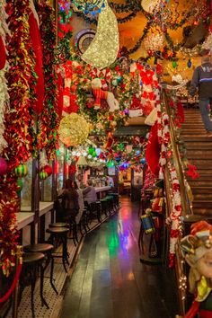 the inside of a restaurant decorated for christmas with lights and decorations hanging from the ceiling