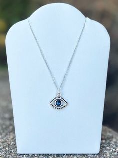 Swarovski crystal evil eye necklace. Charm is antique silver plated and measures 15x16mm. Stainless steel cable chain measures 18in in length. Evil eye necklaces are believed to protect the wearer from negativity directed towards them. Adjustable Silver Evil Eye Necklace, Adjustable Sterling Silver Evil Eye Necklace, Silver Sterling Silver Evil Eye Necklace, Silver Evil Eye Pendant Necklace, Silver Evil Eye Round Pendant Necklace, Silver Metal Evil Eye Jewelry, Silver Necklace With Evil Eye Round Pendant, Silver Metal Jewelry With Evil Eye, Silver Charm Necklace With Evil Eye Pendant