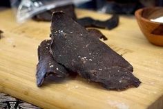 a wooden cutting board topped with pieces of chocolate