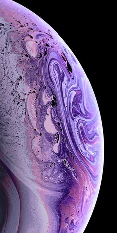 the back side of an iphone with purple and pink swirls on it, against a black background