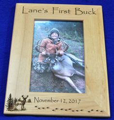 a photo frame with an image of a boy and a deer on it that says lane's first buck