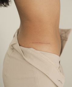 a woman's lower back with the word love written on it