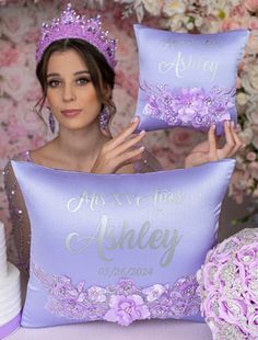 a woman holding two purple pillows with the words, miss and mrs asley on them