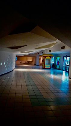 an empty room with tiled floors and walls