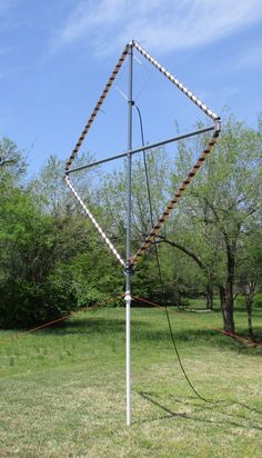 a large metal object sitting on top of a lush green field