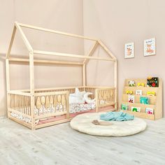 there is a baby crib next to a book shelf with books on the floor