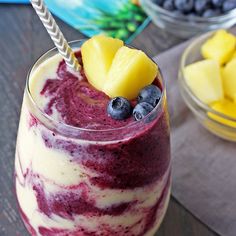 a glass with some fruit in it on a table