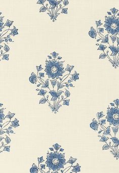 a blue and white wallpaper with flowers on it