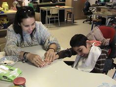 a woman and child sitting at a table together