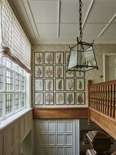 a hallway with pictures on the wall and wooden stairs