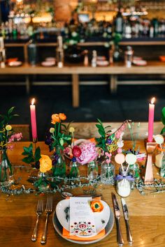 the table is set with flowers and candles