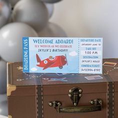 a birthday card sitting on top of a suitcase