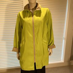 New, Never Worn, This Packable Raincoat Is Perfect For Traveling Or Anytime You Lightweight And Stylish Protection From Wind Or Rain. The Coat Is Completely Reversible With Pockets On Each Side. The Matching Travel Bag Makes It Easy To Pack Or Carry The Boat With You. Full Length Zipper In Front, Hood Packs Neatly Into Collar Without Additional Bulk. Washable, Made In Usa. Received As A Gift And Never Worn; New, No Tags. Fashionable And Convenient. Length = 30”, Collar = 4”, Armpit To Armpit =22 Reversible Long Sleeve Spring Outerwear, Casual Reversible Outerwear For Layering, Casual Green Spring Raincoat, Reversible Hooded Fall Outerwear, Spring Green Nylon Outerwear, Green Spring Travel Outerwear, Hooded Outerwear With Double-lined Hood For Layering, Spring Travel Raincoat With Double-lined Hood, Hooded Spring Travel Outerwear