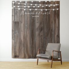 a chair sitting in front of a wooden wall with string lights on it and the word,