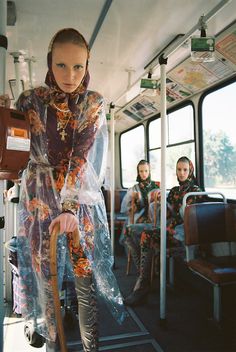 a woman in plastic clothing on a bus