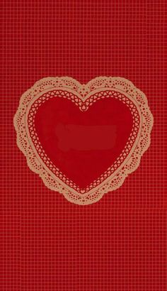 a heart shaped doily on a red background