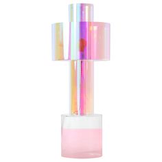 a pink and white vase with a lamp in it's center on a white background